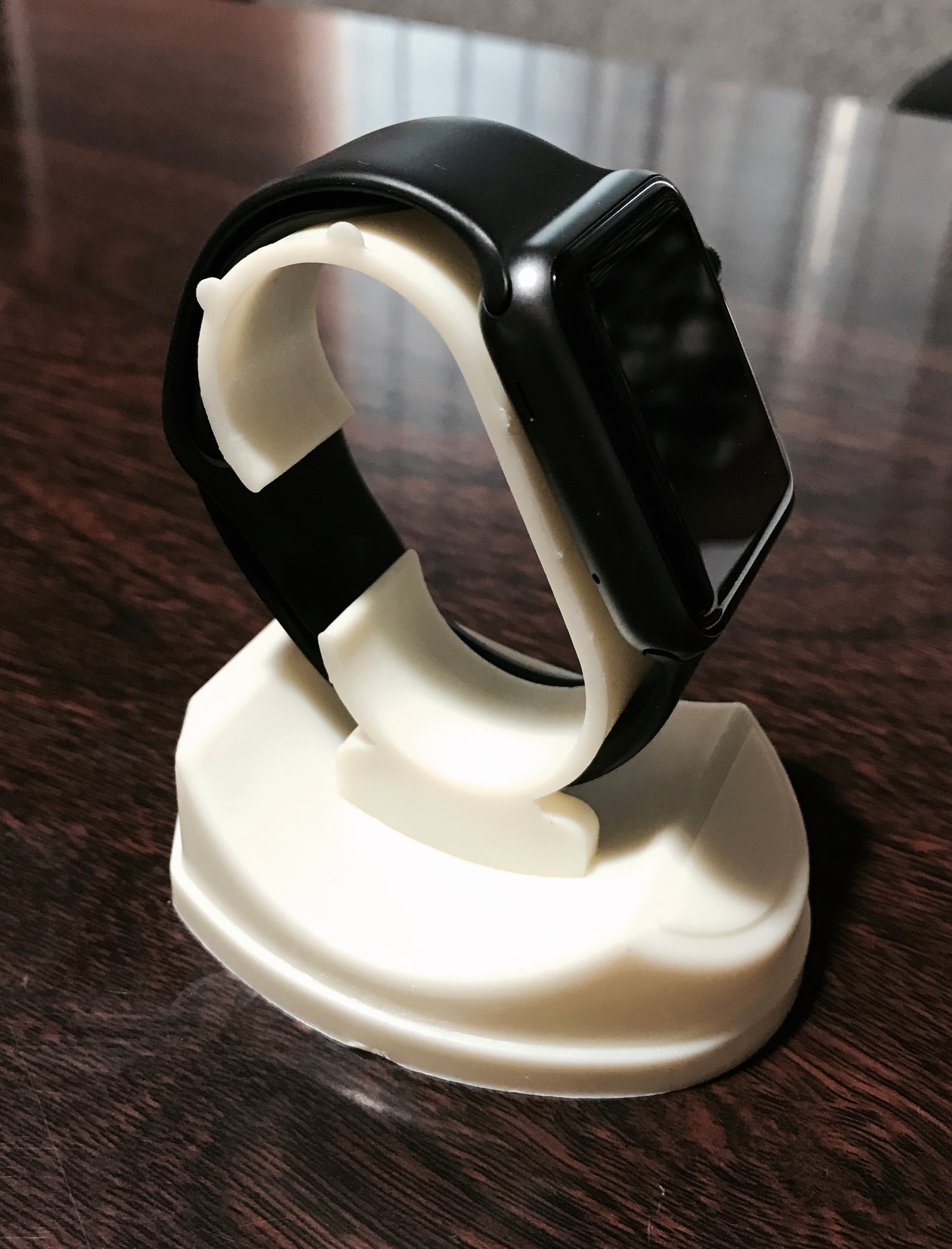 Watch display stand holding an apple watch